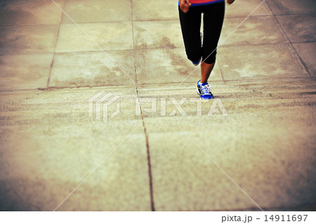 sports woman legs running up on stone stairs sports woman legs running up on stone stairs 14911697