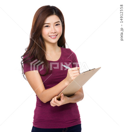 Attractive young woman writes with a clipboard Attractive young woman writes with a clipboard 14912558