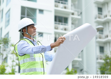 Indian construction engineer looking at site plans Indian construction engineer looking at site plans 14918569