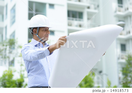 Indian architect looking at blueprints 14918573