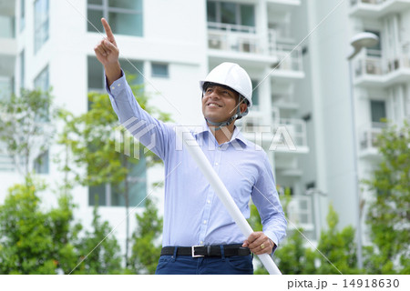 Indian construction engineer holding blueprints 14918630