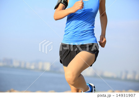 Runner athlete running at seaside city 14931907