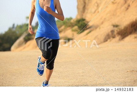 young woman runner legs running on seaside mountai young woman runner legs running on seaside mountai 14932183