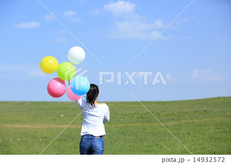 young asian woman running with balloons young asian woman running with balloons 14932572