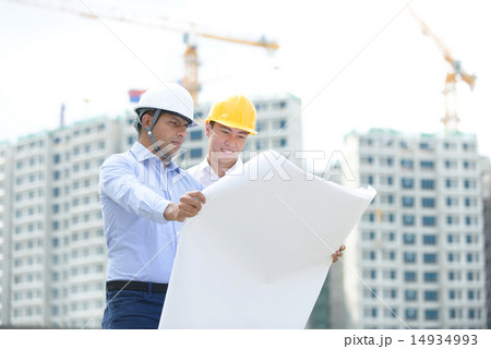 2 contractors looking at blueprints 2 contractors looking at blueprints 14934993