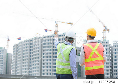 Back view of 2 contractors at a construction site 14935058