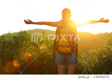 thankful woman hiker open arms to the sunrise   14936070