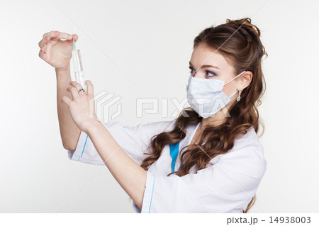 Young intern is practiced with syringe isolated on white  14938003
