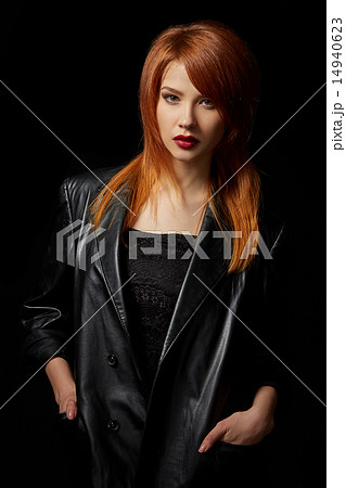Sexy red-haired model posing in leather jacket Sexy red-haired model posing in leather jacket 14940623