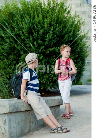 Girl and boy playing a pipe in nature Girl and boy playing a pipe in nature 14967286