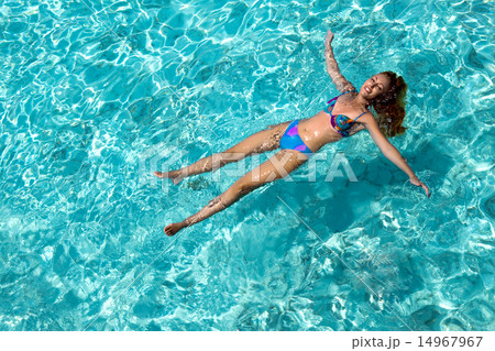 Young woman smiles, swiming in ocean, Maldives 14967967