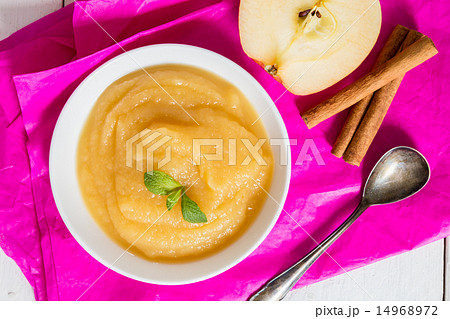 Applesauce on pink paper and spoon 14968972