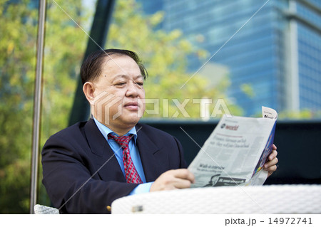 Asian businessman reading newspaper 14972741