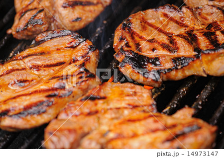 barbecueing meat 14973147