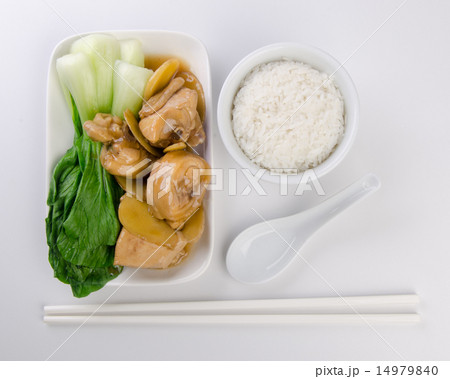 Chicken with rice and vegetables in background 14979840