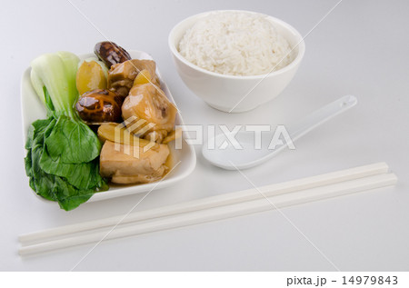 Chicken with rice and vegetables in background 14979843