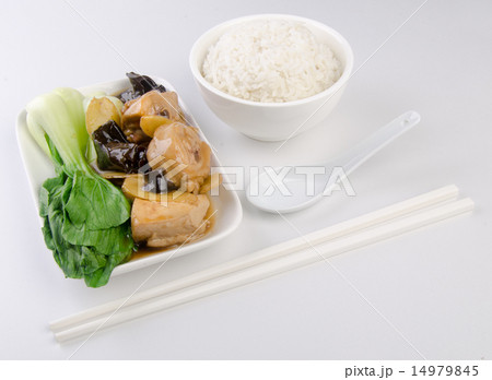 Chicken with rice and vegetables in background Chicken with rice and vegetables in background 14979845