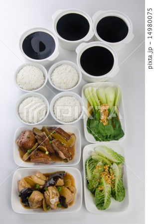 Chicken with rice and vegetables in background. 14980075