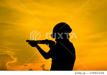 Silhouette boy holding shotgun with sun set. Silhouette boy holding shotgun with sun set. 14983206