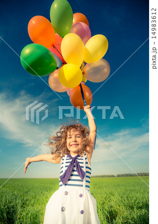 Child with toy balloons in spring field Child with toy balloons in spring field 14983612