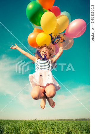 Child with toy balloons in spring field Child with toy balloons in spring field 14983613