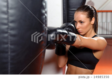 Female boxer with punching bag 14985350