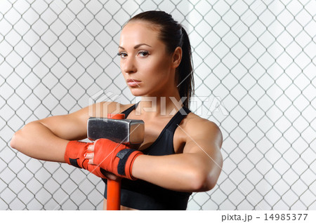 Sportswoman with a hummer in gym 14985377