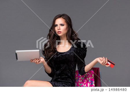 Beautiful young girl paying by credit card for shopping  14986480