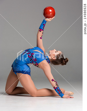 teenager doing gymnastics exercises with red gymnastic ball teenager doing gymnastics exercises with red gymnastic ball 14986928