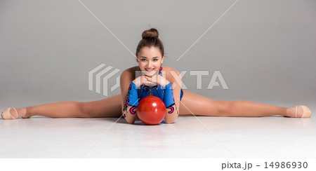 teenager doing gymnastics exercises with red gymnastic ball teenager doing gymnastics exercises with red gymnastic ball 14986930