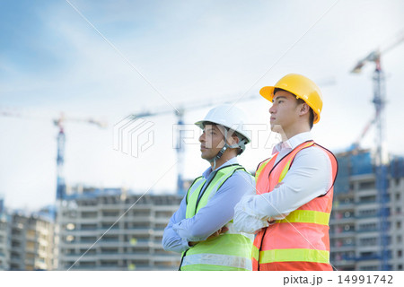 Construction team in front of construction site Construction team in front of construction site 14991742