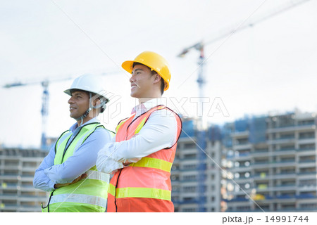 Construction team in front of construction site Construction team in front of construction site 14991744
