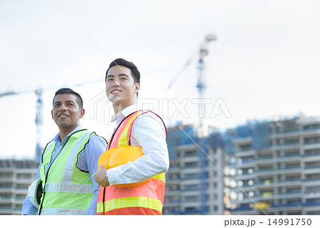 Construction team in front of construction site 14991750