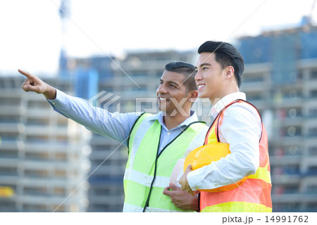 Construction team in front of construction site 14991762