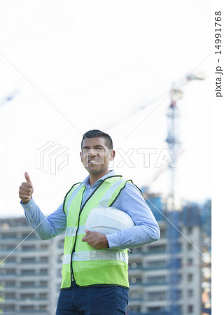 Indian engineer in front of construction site Indian engineer in front of construction site 14991768