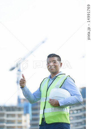 Indian engineer in front of construction site Indian engineer in front of construction site 14991769