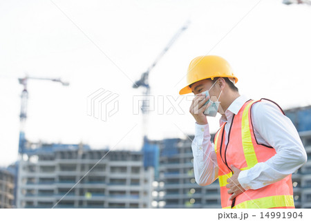 Chinese construction worker coughing Chinese construction worker coughing 14991904