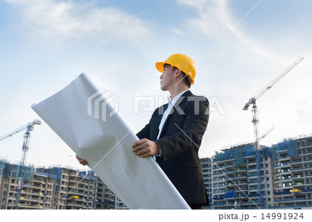 Young Chinese architect holding blueprints 14991924