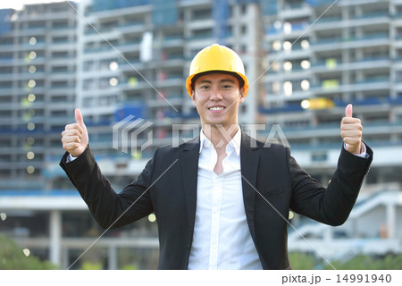 Young Chinese architect giving thumbs up 14991940
