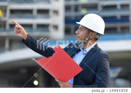 Indian architect holding document file Indian architect holding document file 14991959