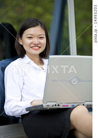 Asian young female executive using laptop Asian young female executive using laptop 14993203