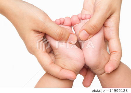 mother massaging little baby's feet mother massaging little baby's feet 14996128