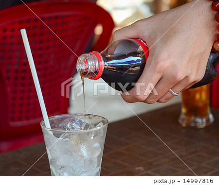 Pouring cola into the glass 14997816