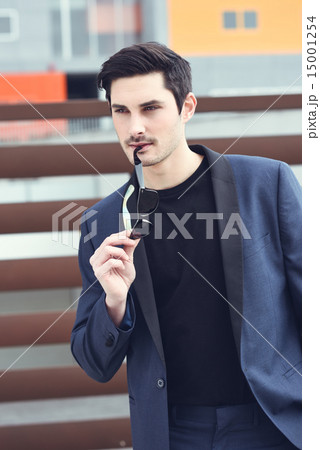 Man, model of fashion, wearing modern suit and sunglasses. Man, model of fashion, wearing modern suit and sunglasses. 15001254