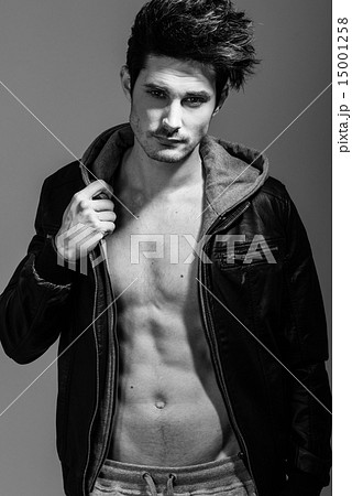 Athletic man wearing hoodie jacket. Studio shot Athletic man wearing hoodie jacket. Studio shot 15001258
