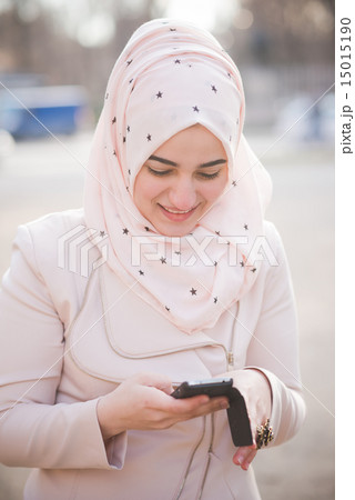young beautiful muslim woman at the park young beautiful muslim woman at the park 15015190