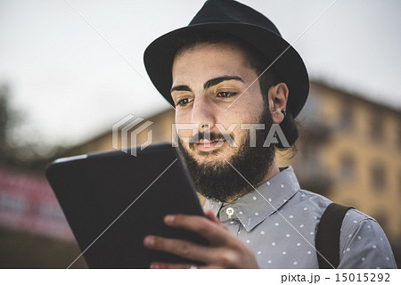 young handsome hipster gay modern man using tablet 15015292