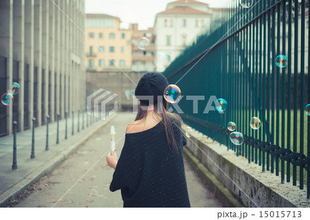 young beautiful brunette woman girl blowing bubbles soup 15015713