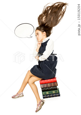 Isolated shot of thoughtful schoolgirl sitting on pile of books 15019204