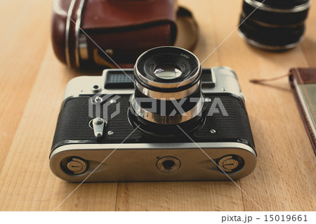 retro camera with portrait lens lying on wooden 15019661